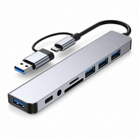 8-in-1 multiport USB-C hub with USB ports and card reader on white background