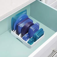 Cabinet lid holder designed for container lids and small kitchen storage items.