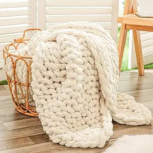 Soft chunky chenille knit blanket draped over sofa