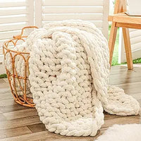 Soft chunky chenille knit blanket draped over sofa