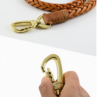 Dog leash with cowhide handle and metal attachment hook