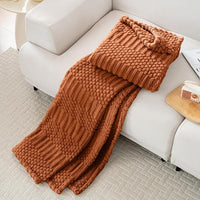 Plush decorative blanket on bedroom bed setup