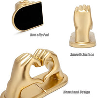 Gold decorative hand bookends displayed on a living room shelf