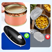 Black electric can opener shown with canned vegetables and soup ingredients during meal preparation.