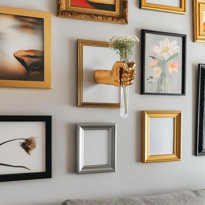 Decorative hand-shaped vase adding a floral accent to an entryway wall