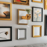 Decorative hand-shaped vase adding a floral accent to an entryway wall