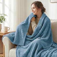 Cozy fleece throw blanket spread across modern bed
