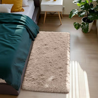 Beige fluffy shag rug placed in bedroom beside bed