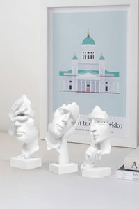Side view of white decorative figures with smooth resin detailing