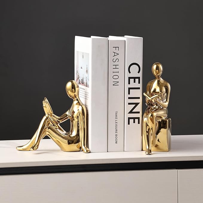 Gold ceramic statue bookends supporting books on a shelf