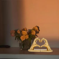 Gold hand-shaped bookends supporting books on a shelf