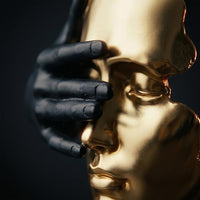 Decorative gold statue displayed as a focal accent on a modern tabletop