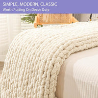 Thick hand knitted jumbo yarn throw blanket on bed