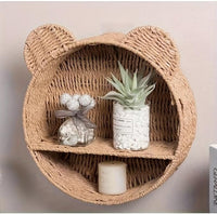 Handwoven wicker nursery shelf, wall mounted bookshelf for baby room decor.