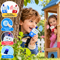 Boy and girl using colorful police car walkie talkies while playing outdoors near a wooden playhouse.