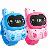 Blue and pink kids walkie talkie wrist watches with digital displays and adjustable straps on a white background.