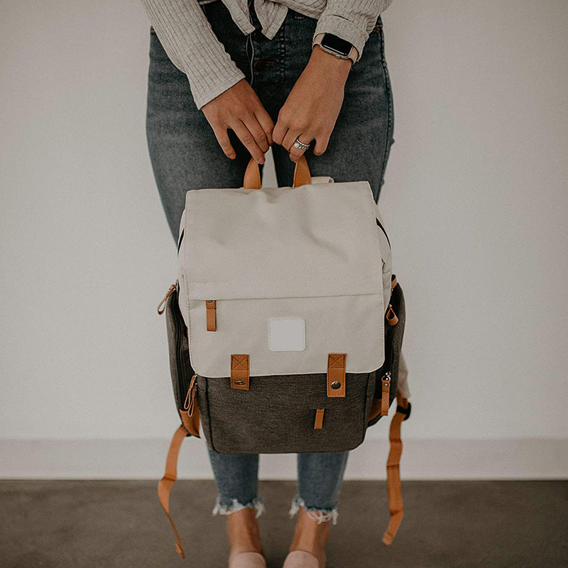 Large diaper backpack with stroller straps, ideal for hands-free convenience.