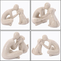 Resin man and dog sculpture arranged on a contemporary living room bookshelf
