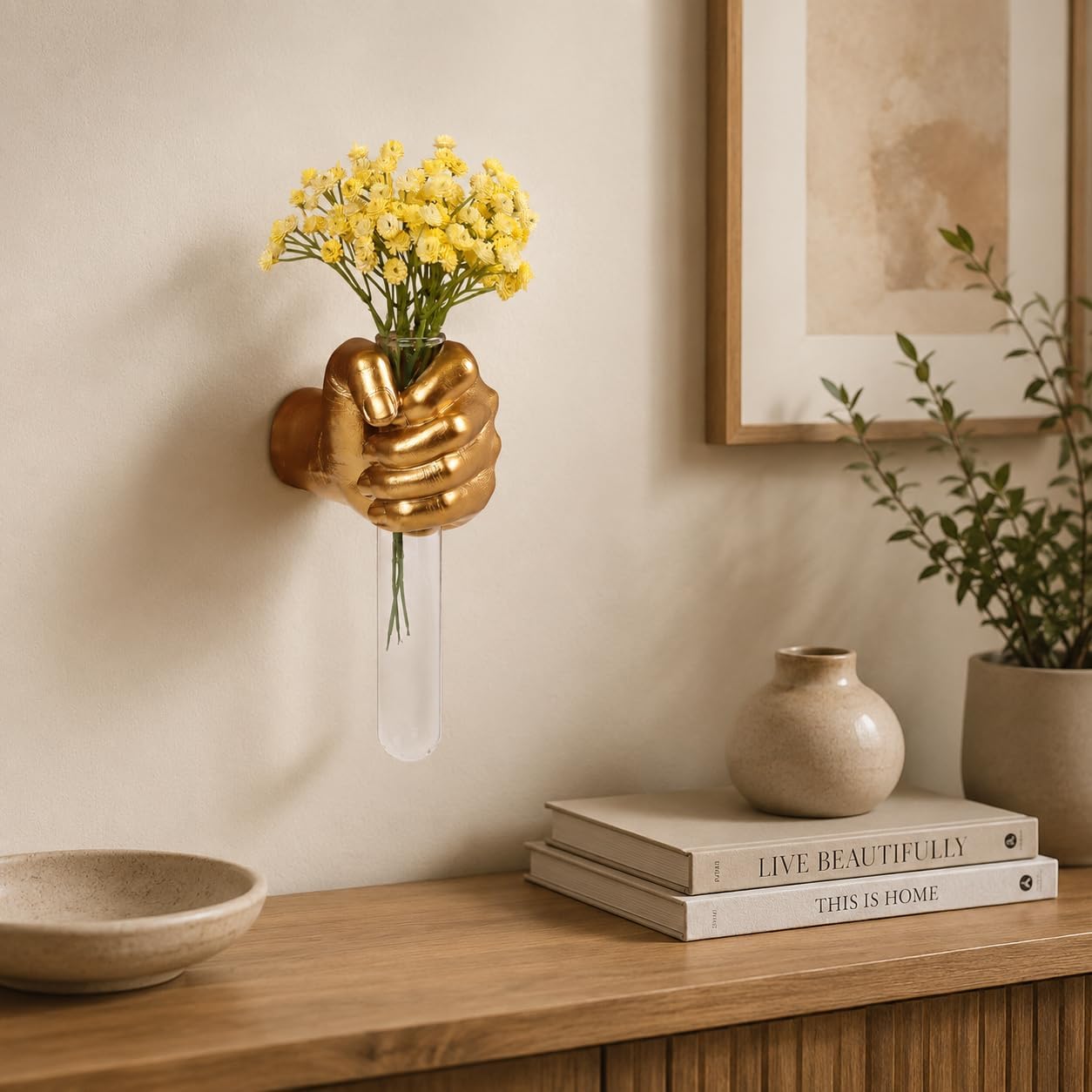 Sculptural gold floral holder displayed on a modern living room wall
