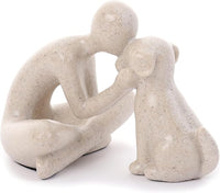 Hand-painted resin figurine showing a seated man gently embracing a dog