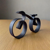 Compact wire bicycle ornament positioned on a clean office desk
