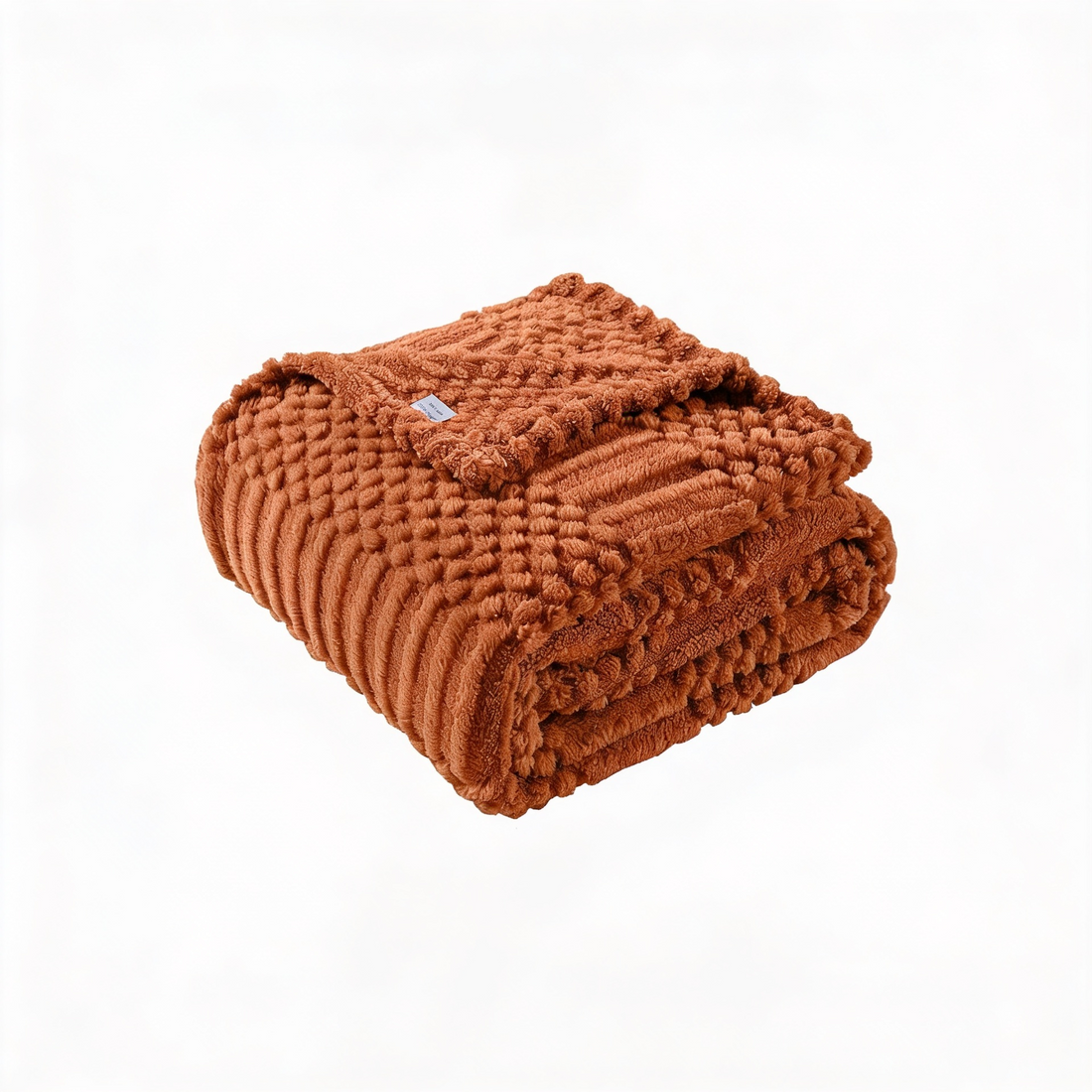 Soft rust fleece blanket draped over modern sofa
