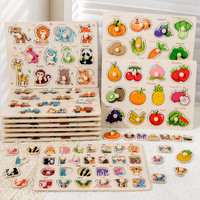 A colorful children's educational puzzle toy set featuring animal and fruit/vegetable cutout boards with labeled pieces, arranged on a white textured surface.
