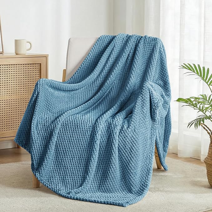 Soft slate blue waffle textured fleece blanket on couch