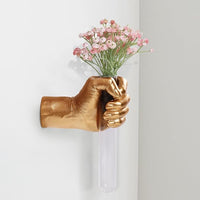 Hand-shaped wall flower holder arranged with a single decorative stem