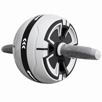 Ab wheel being used for kneeling rollout exercises on a flat workout surface.