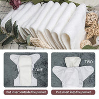 Close up of the adjustable snap buttons on a white cloth nappy cover