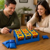 Adults playing tic tac toe toss game with blue bean bags for fun table game activity