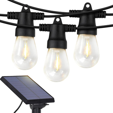 Solar powered outdoor string lights with soft white LED Edison bulbs lighting up a porch.