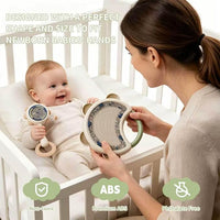Assorted infant grab and shake rattles arranged on a plain background