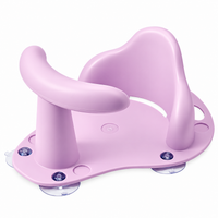 - Teal and yellow infant bath seat installed in a compatible bathtub during a supervised bathing setup.