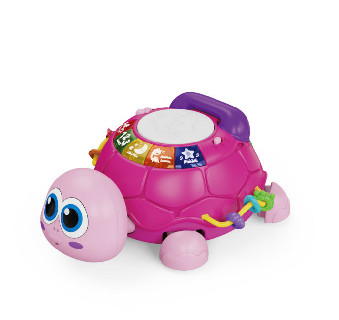 A pink and purple turtle-shaped activity toy with large cartoon eyes, a white drumming top