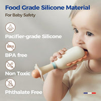 Baby holding a dinosaur rattle during supervised playtime