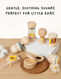 Baby holding a colourful wooden rattle during supervised play