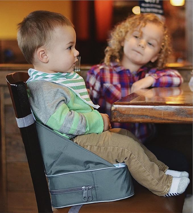 Baby Sitting Comfortably in a Portable Travel Booster Seat for Feeding