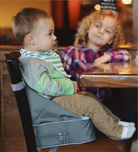 Baby Sitting Comfortably in a Portable Travel Booster Seat for Feeding