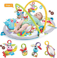Baby lying on activity play gym with overhead toys