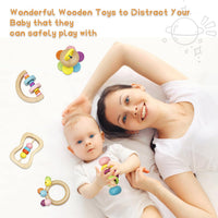 Baby holding a colorful wooden rattle during supervised playtime