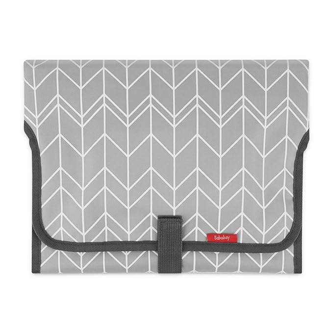 Packaged portable changing pad displayed as a baby shower registry gift