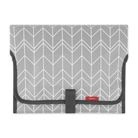 Packaged portable changing pad displayed as a baby shower registry gift