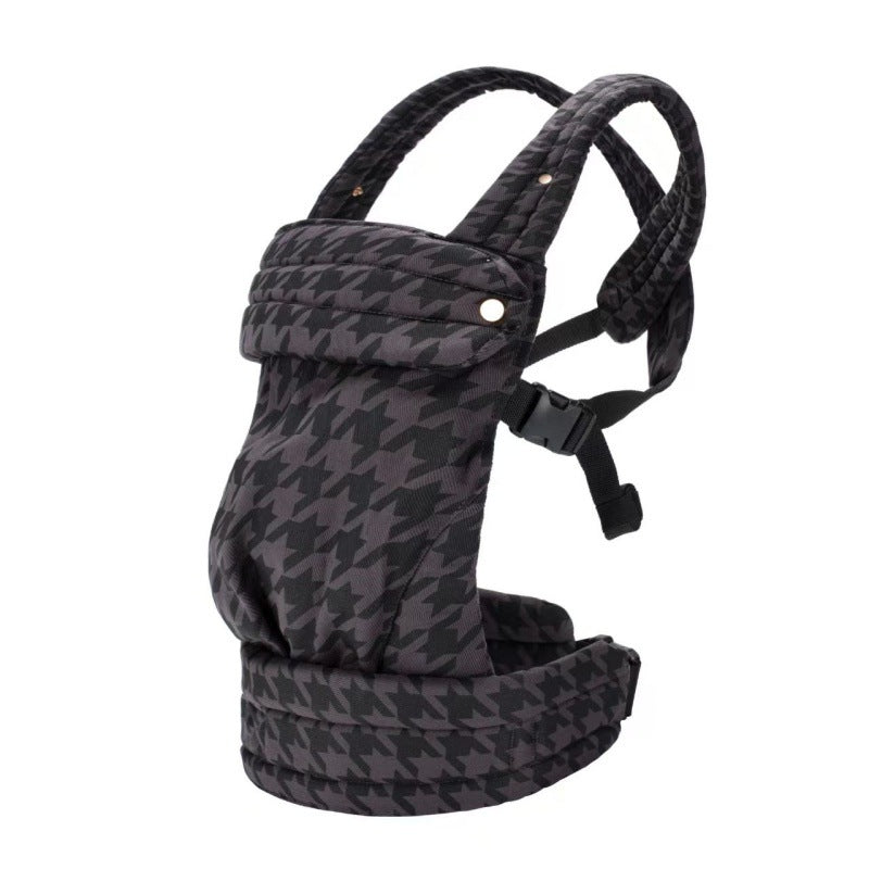Detailed view of the infant carrier's fastening mechanism and connecting straps.