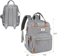 Gray diaper bag displayed with its matching foldable cushioned changing pad and pacifier pod