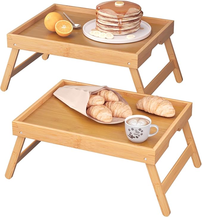 Two bamboo bed tray tables with folding legs in natural finish