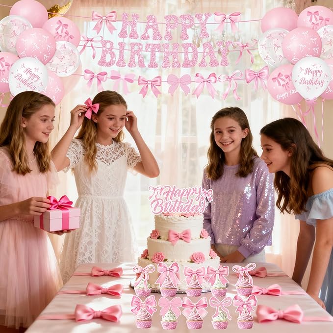 Birthday party table decorations with pink bow theme plates, napkins, and cups