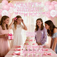 Birthday party table decorations with pink bow theme plates, napkins, and cups