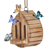 Wooden butterfly house hanging near a tree